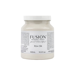 May include: A white plastic jar of Fusion Mineral Paint in the color Raw Silk. The jar is labeled with the Fusion logo and the words 'paint it beautiful.' The jar is 500mL and 16.9 fl oz.