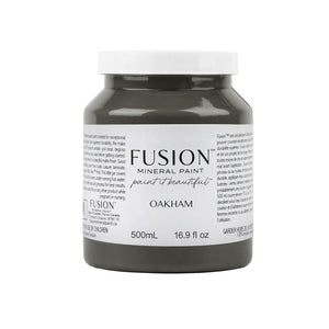 May include: A round jar of Fusion Mineral Paint in the color Oakham. The jar is gray and has a white label with black text. The text on the label reads 'Fusion Mineral Paint paint it beautiful Oakham 500mL 16.9 fl oz'.